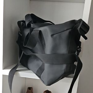 Rains Black Duffel Bag with Minimalist Design